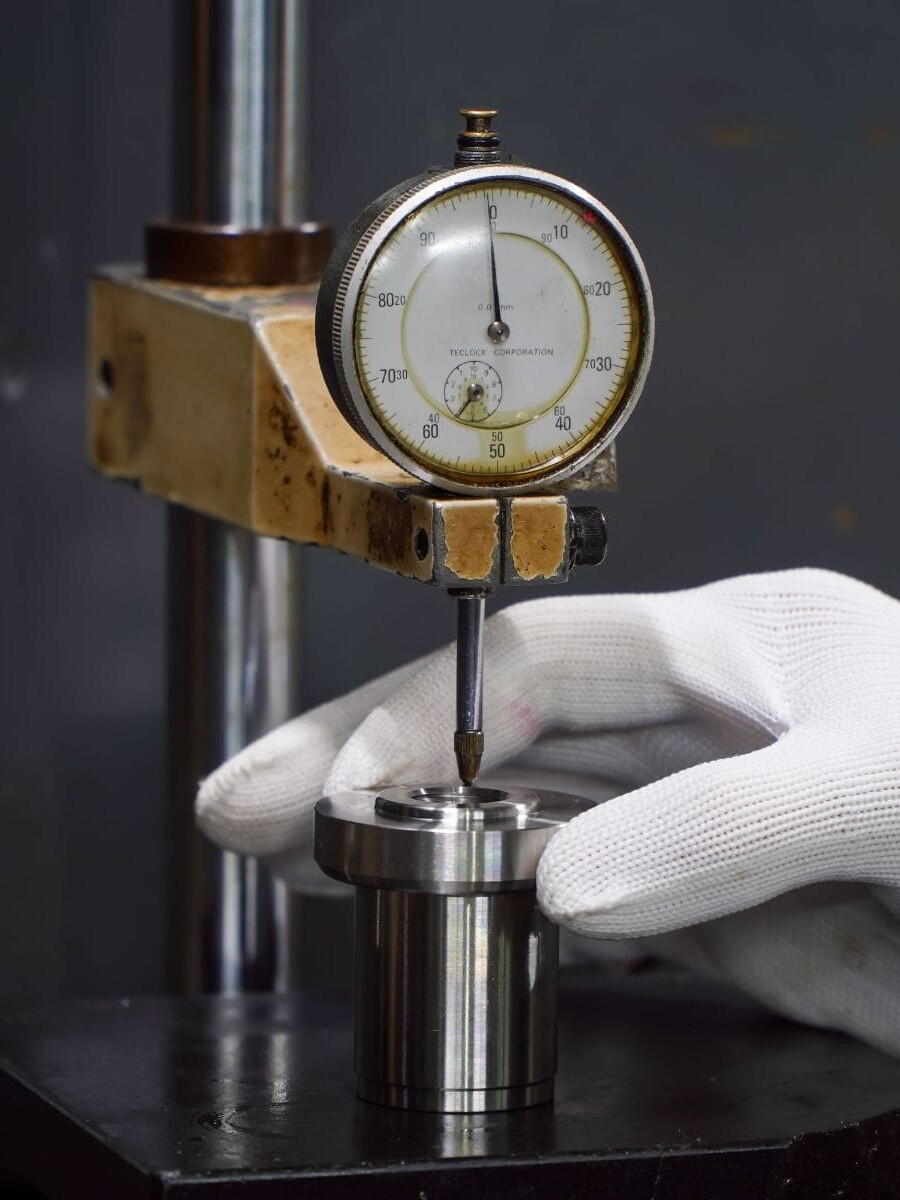 An operator handling a dial indicator
