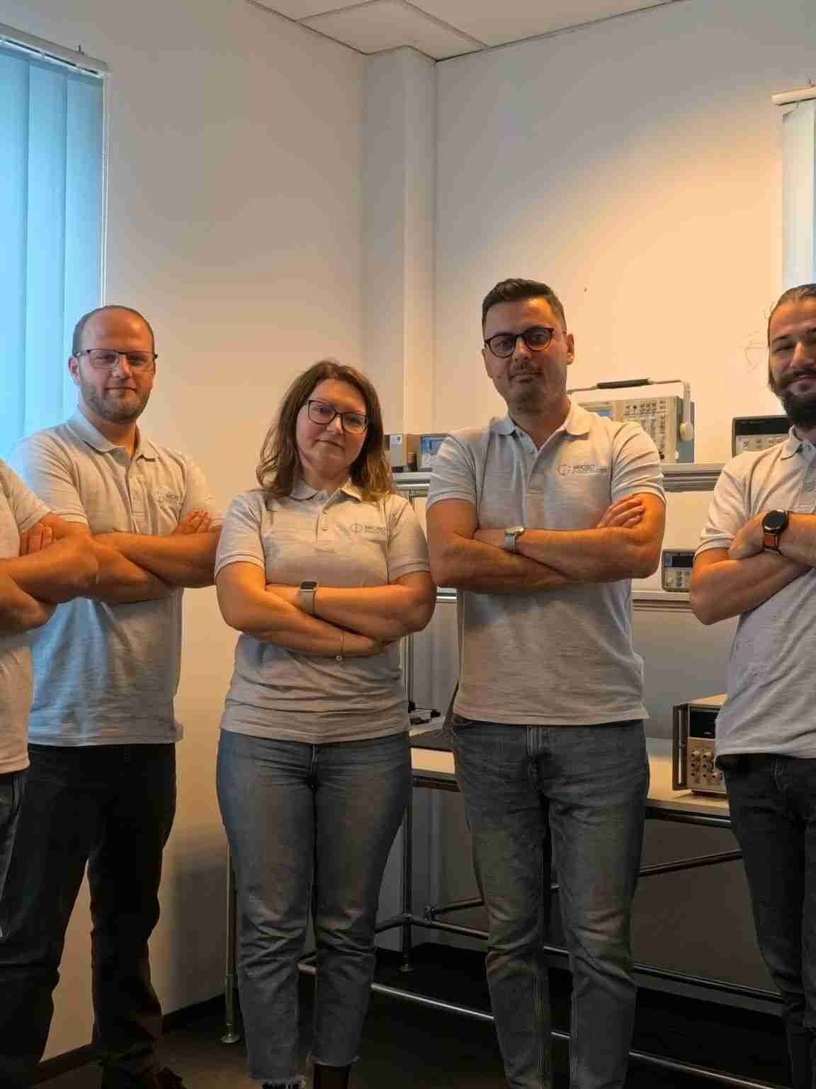Micro Precision Romania team in Timișoara lab with test equipment.