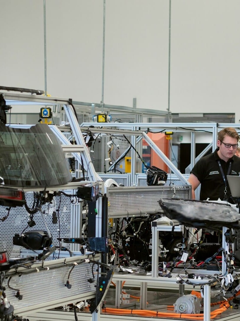 engineers and staff inside automotive manufacturing facility