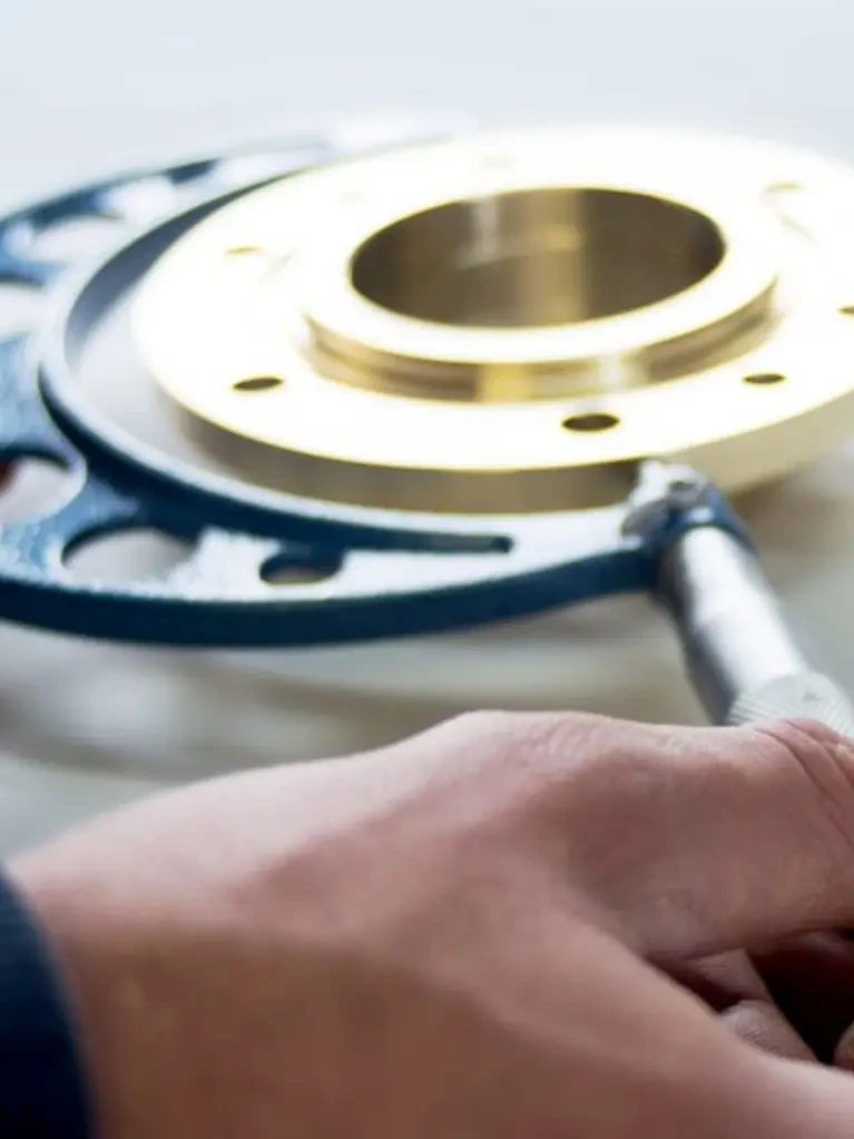 Calibration technician using a precision caliper to demonstrate As Found / As Left in Calibration measurement recording in a metrology laboratory