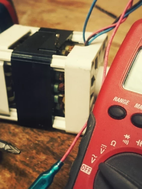 Digital multimeter measuring voltage on an electrical component — the kind of calibrated instrument reading a customer quality audit checks for traceability